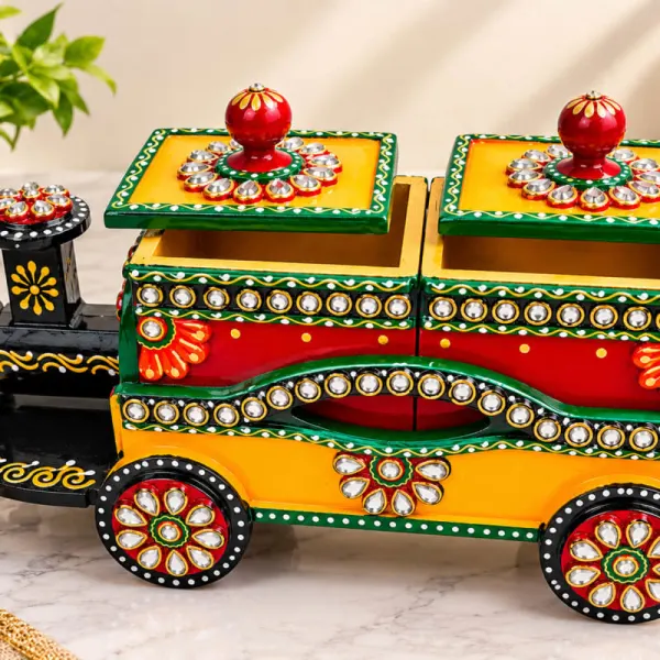 Beautiful handcrafted Indian folk-art train-shaped decorative storage box with intricate mirror work and vibrant hand-painted detailing.