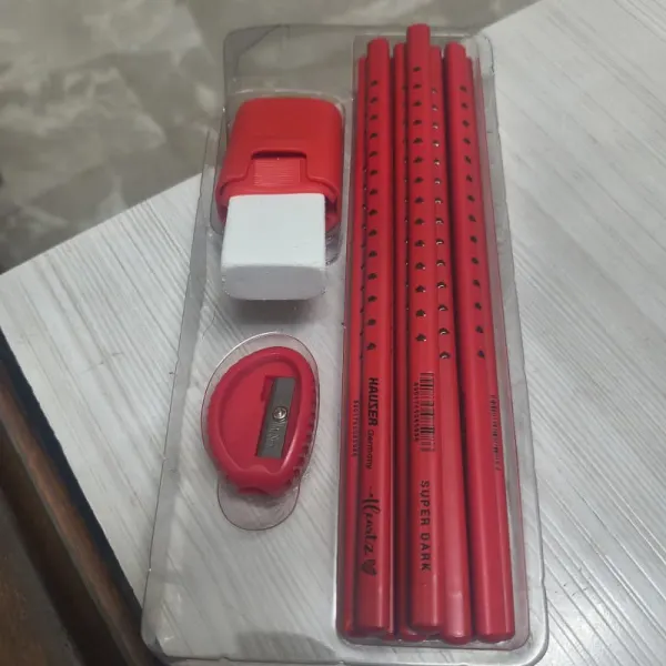 Red colour wooden pencil with sharpner and rubber