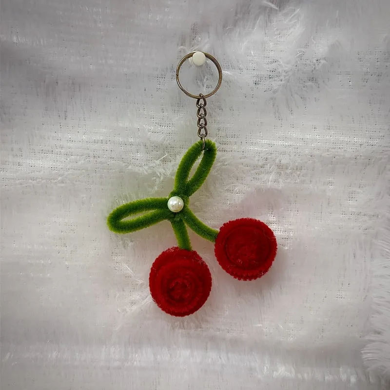 Carry a splash of sweet summer with this hand‑crafted cherry keychain, made with