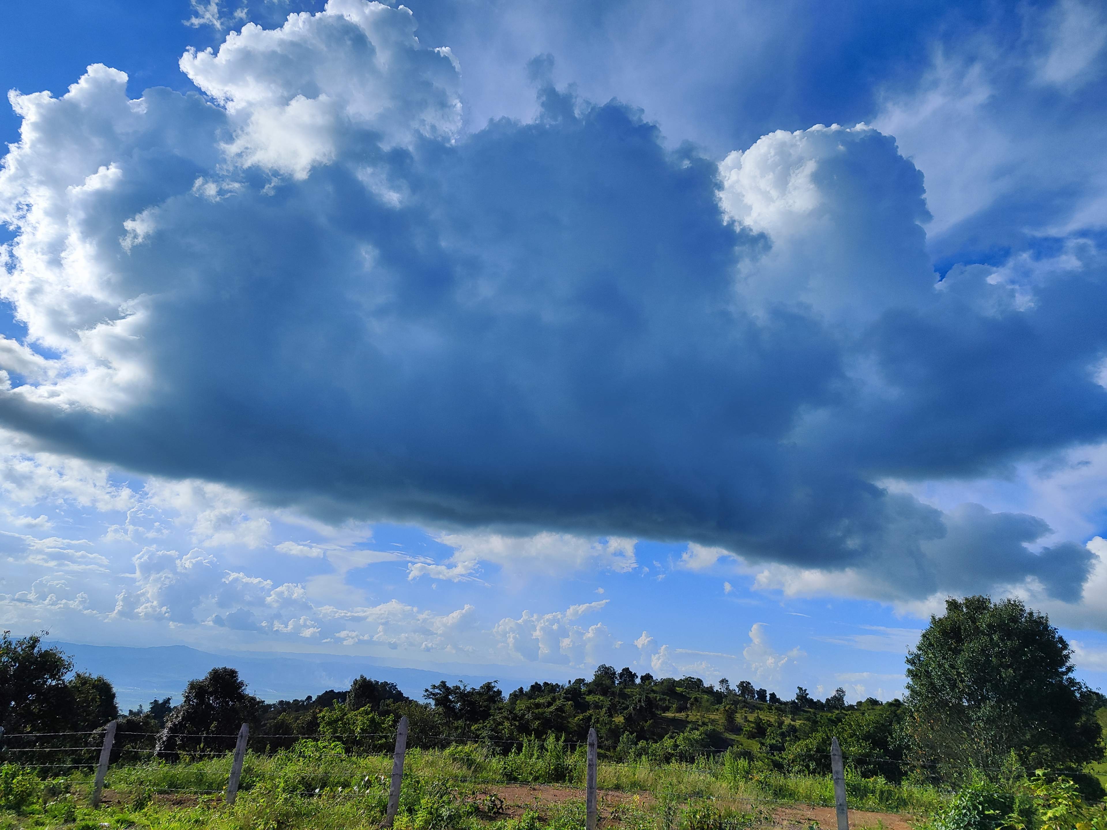 huge_storm_cloud_above_the_green_hills