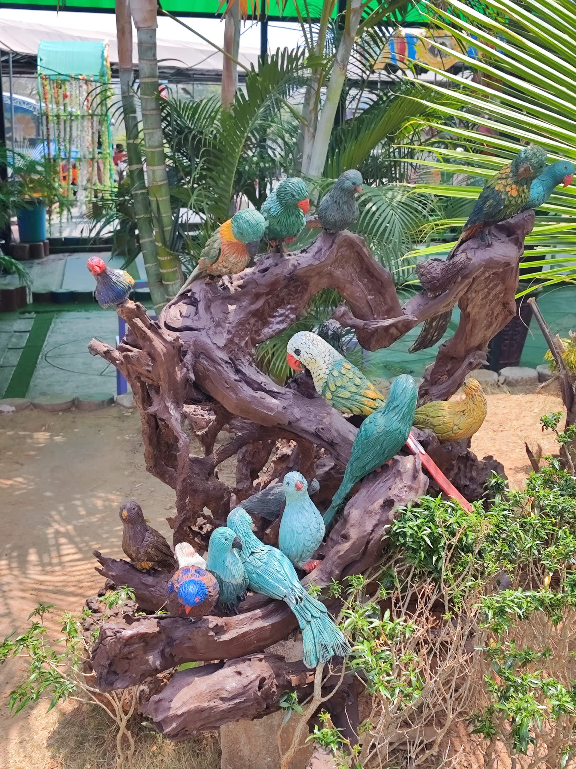 colorful_wooden_bird_statues_in_garden