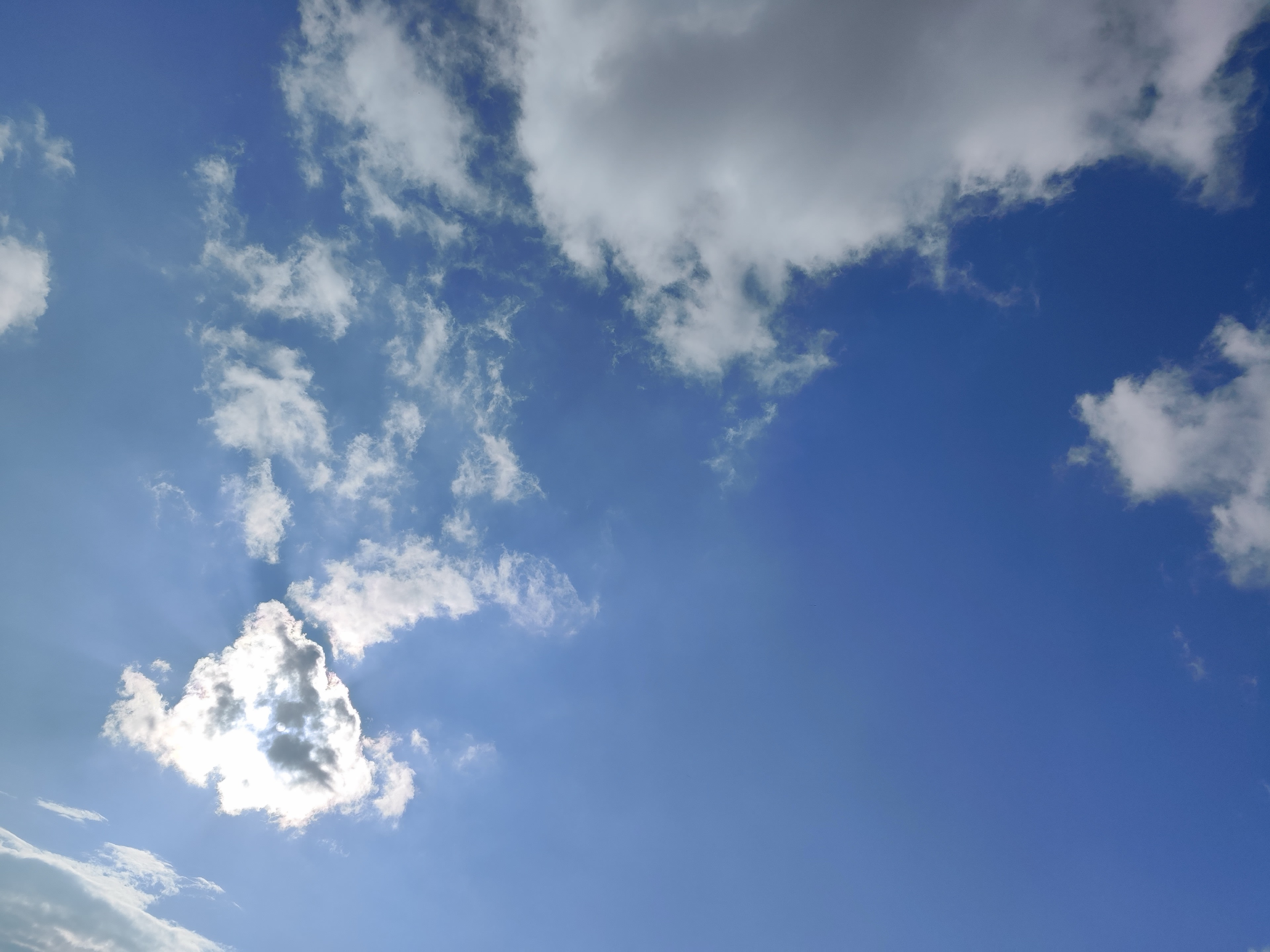 Silver lining cloud in bright blue sky