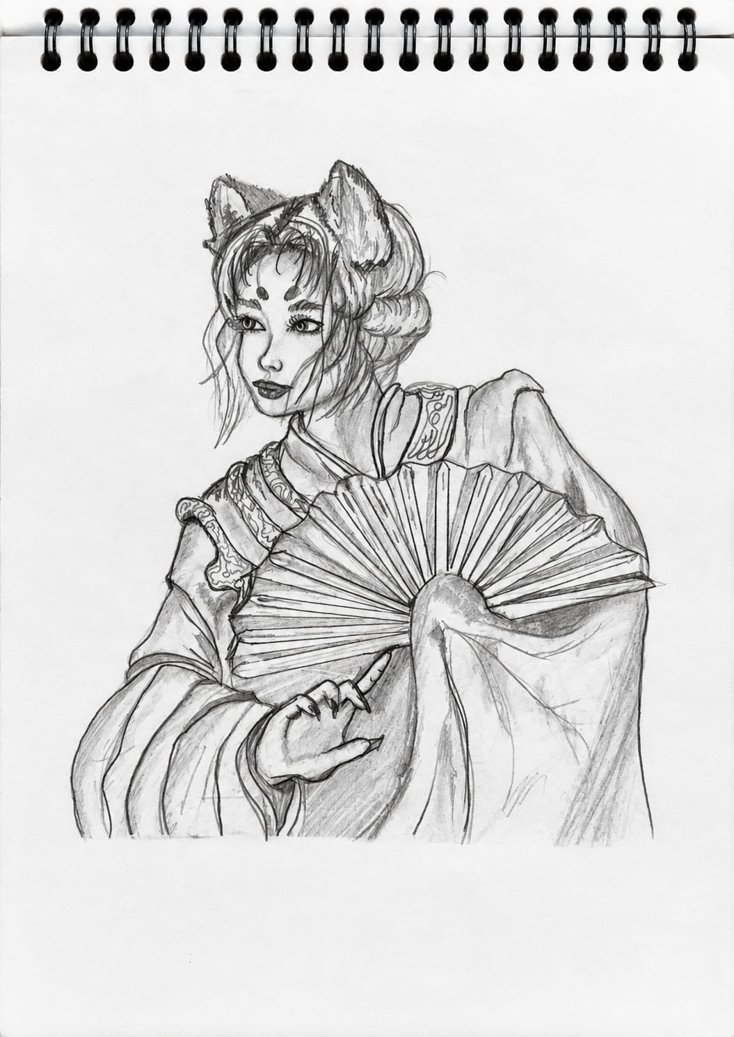 A graphite pencil drawing of a female figure inspired by Japanese fox folklore, with fox ears, traditional-style clothing, and a decorative folding fan held across her body. The character is drawn on a spiral sketchbook page in a monochrome style.