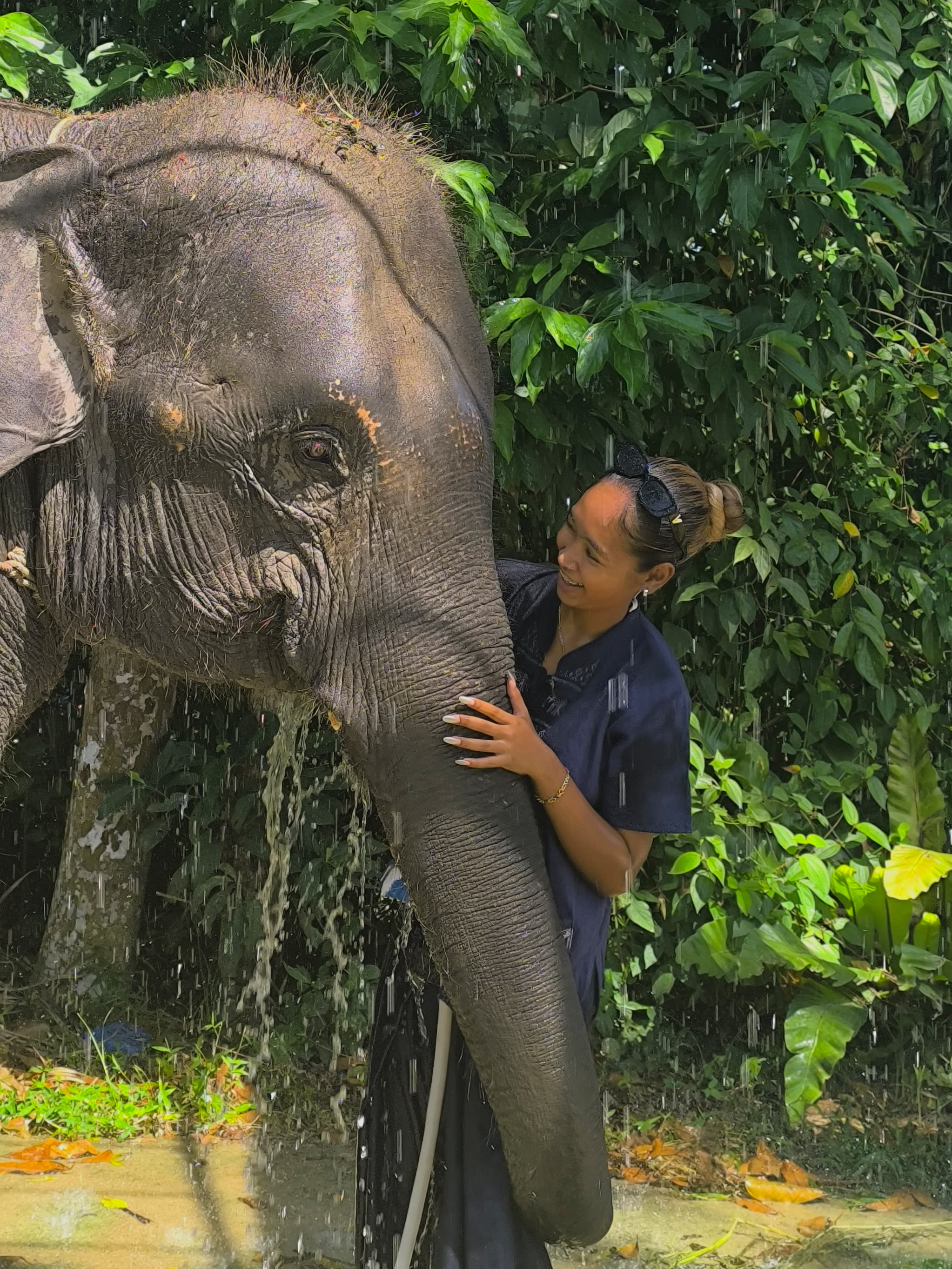 A person having a joyful interaction with an elephant.