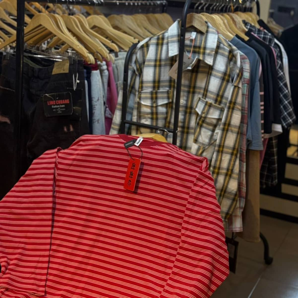 Mixed Clothing Rack — Plaid Shirts & Red Striped Tee