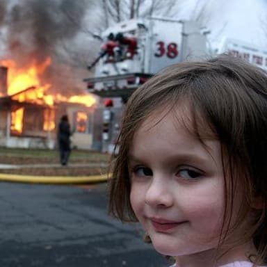 Disaster Girl meme template: A young girl smirks at the camera in the foreground, while a house burns in the background with firefighters and a fire truck present.