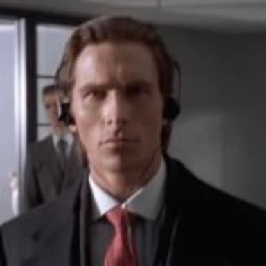 Bateman Walking meme template: A close-up of Patrick Bateman in a suit, looking intensely forward with headphones on, suggesting a focused or obsessive state.