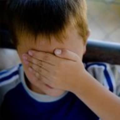 Confession Kid meme template: A young boy covers his eyes with his hand, looking embarrassed or ashamed.