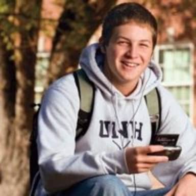 College Freshman meme template: A young man with a backpack and earbuds, holding a portable music player, looks happy and oblivious.