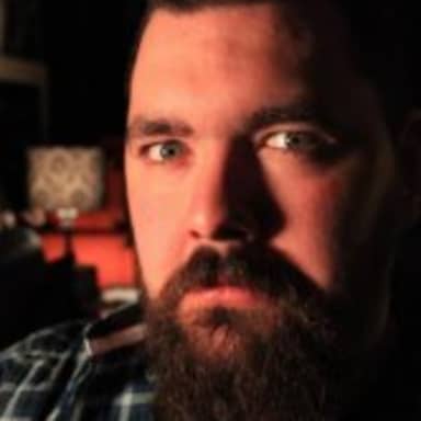 Dating Site Murderer meme template: A man with a beard stares intensely into the camera with a dark background.