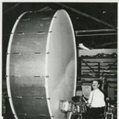 Big Ego Man meme template: A man sits behind a very small drum set next to a gigantic bass drum.