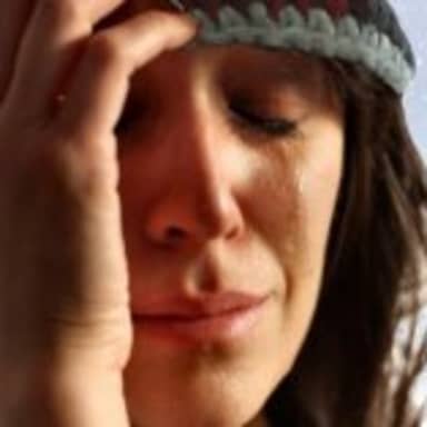 1st World Canadian Problems meme template: A woman in a beanie cries with snow falling and snow-covered trees in the background.