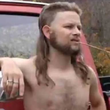 Almost Politically Correct Redneck meme template: A shirtless man with a mullet and beard is leaning on the side of a red pickup truck, chewing on a twig.