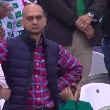 Disappointed Man meme template: A man with a bald head and a disappointed expression, wearing a puffer vest over a plaid shirt, stands with his arms crossed.