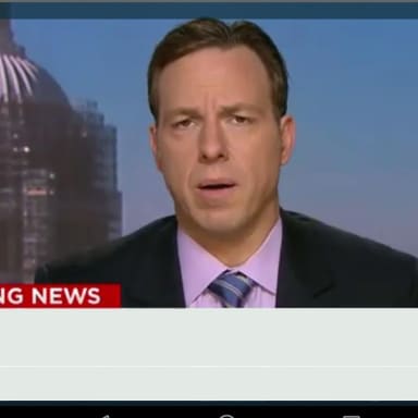 Cnn Breaking News Template meme template: Jake Tapper of CNN is reporting live from Washington DC, with the Capitol Building under scaffolding in the background. A banner reads 'BREAKING NEWS'.