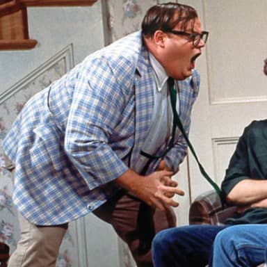 Chris Farley For The Love Of God meme template: A man in a plaid jacket and tie leans forward with his mouth wide open, looking agitated and addressing someone off-screen. A second person is partially visible sitting down in the foreground.