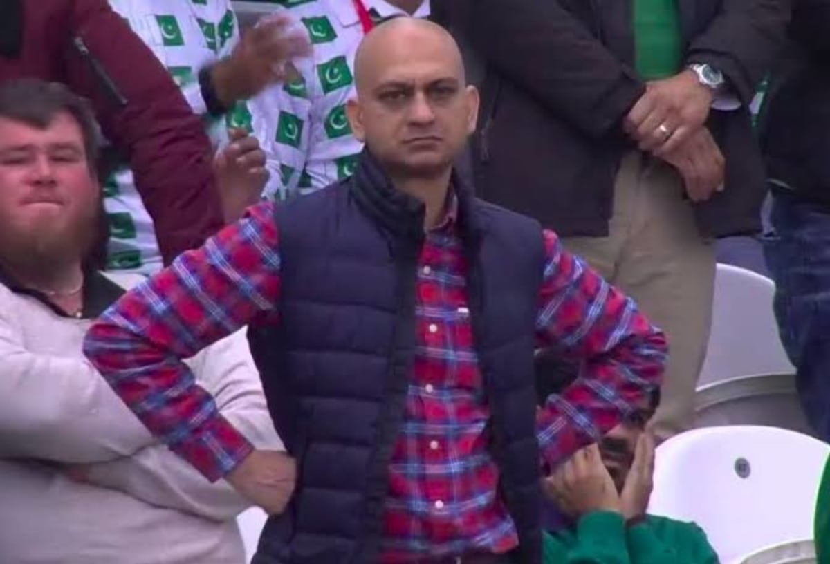 Disappointed Man meme template: A man with a bald head and a disappointed expression, wearing a puffer vest over a plaid shirt, stands with his arms crossed.