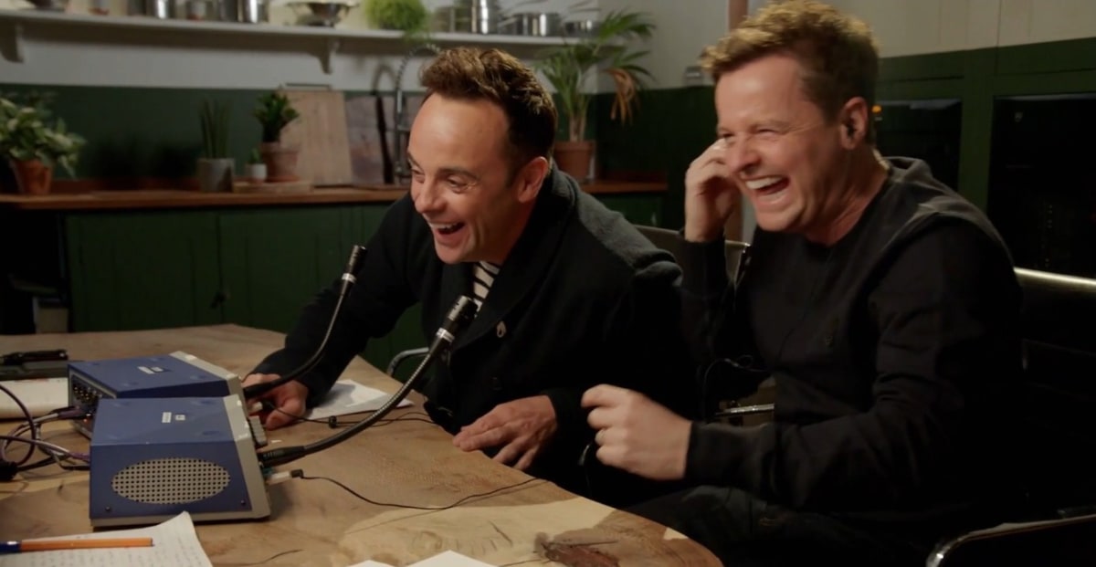 Ant And Dec Laughing meme template: Two men, Ant and Dec, are sitting at a table and laughing heartily while looking at something off-camera. Each has a microphone in front of them and appears to be reacting to a shared experience.