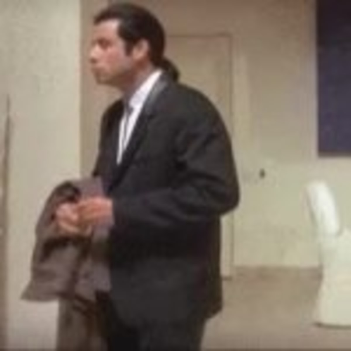 Confused John Travolta Pulp Fiction meme template: John Travolta in a suit, looking around confused and bewildered.
