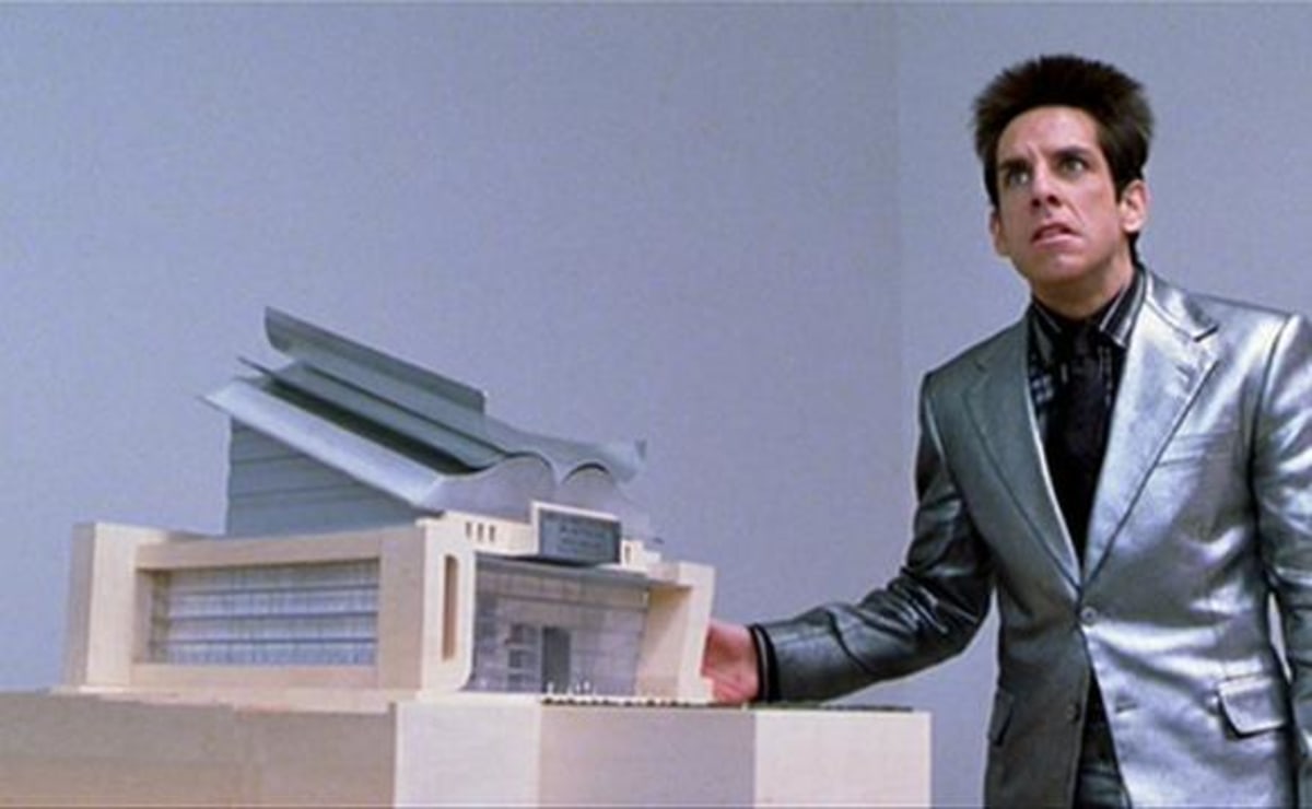 A Center For Ants? meme template: A man in a shiny suit presenting a small architectural model with a confused, concerned expression.