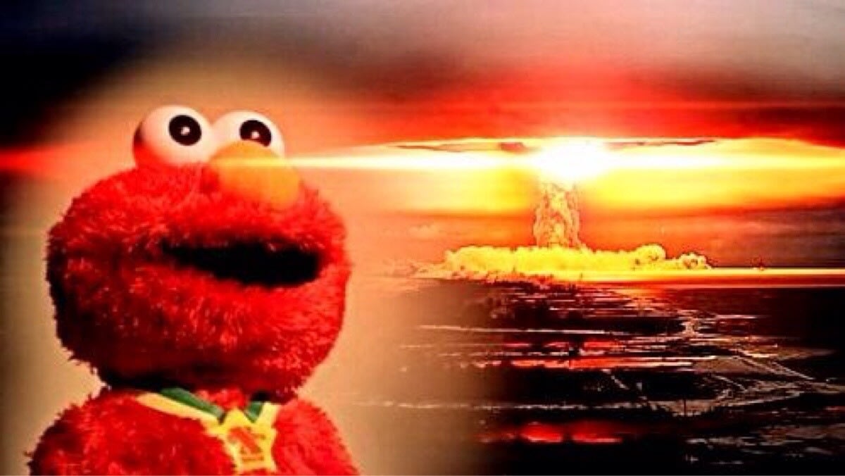 Elmo Nuclear Explosion meme template: Elmo with a wide, unsettling smile stares forward as a nuclear explosion erupts in the background.