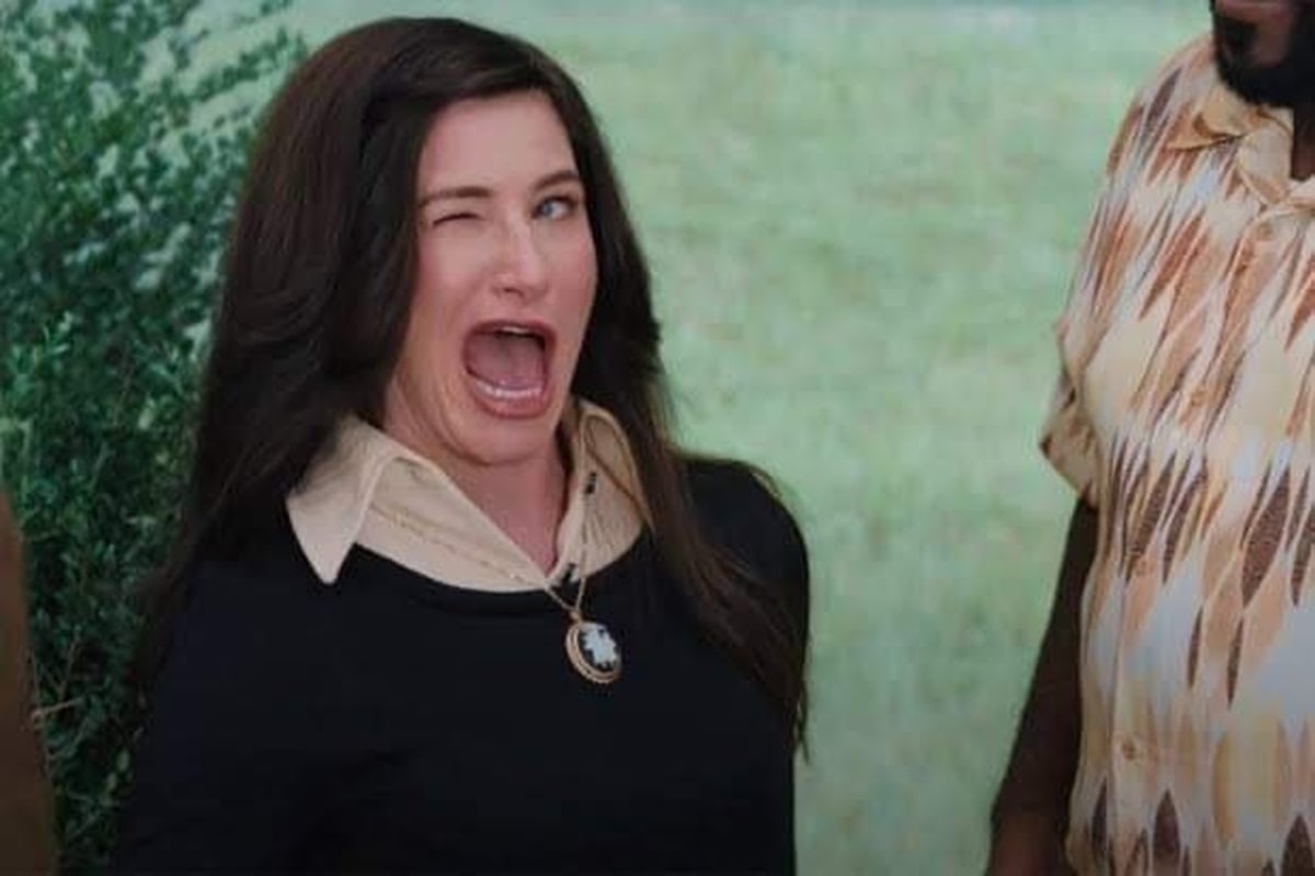 Agnes Harkness Winking meme template: A woman winks and screams with her mouth wide open, her face contorted in an exaggerated expression.