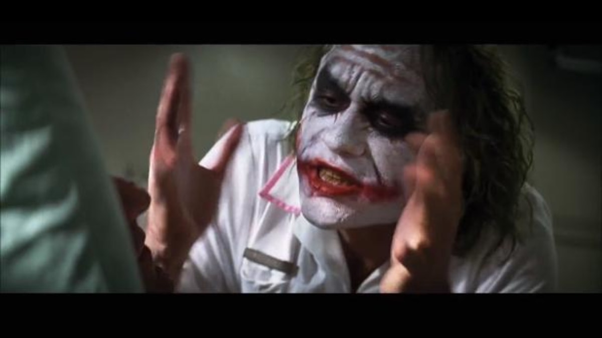 And Everybody Loses Their Minds meme template: A chaotic close-up of the Joker in a white shirt, with his face painted, making frantic gestures with his hands.