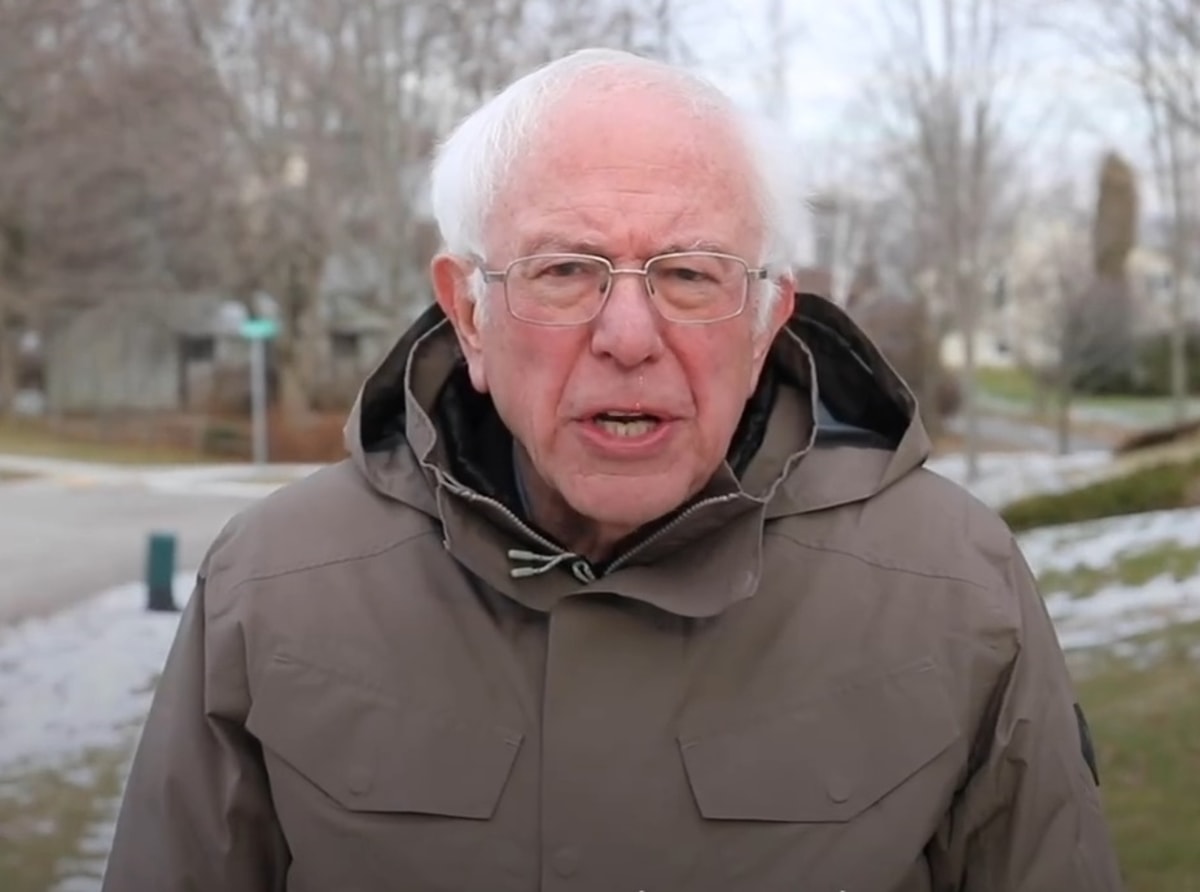 Bernie Sanders Once Again Asking meme template: Bernie Sanders in a winter coat, looking directly at the camera with an earnest expression.