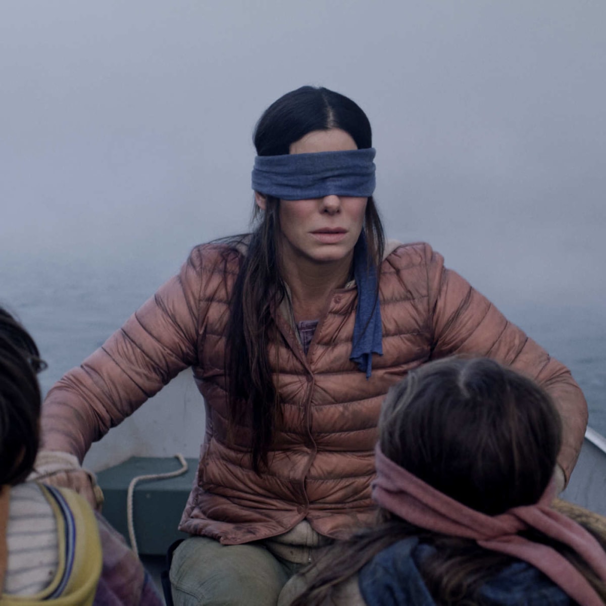 Bird Box meme template: A woman and two children wearing blindfolds in a small boat.