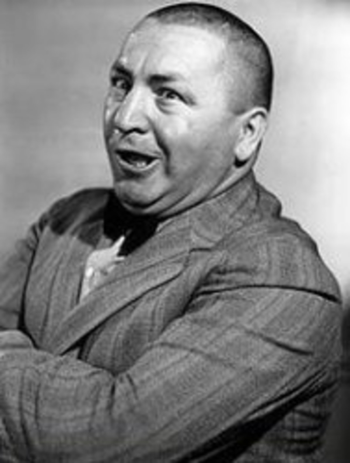 CURLEY meme template: A close-up, black and white photo of Curly Howard of The Three Stooges, with his arms crossed and a confused, slightly bewildered expression.