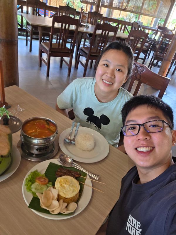 2 humans with tom yum soup, fried rice with chicken satay and coconut