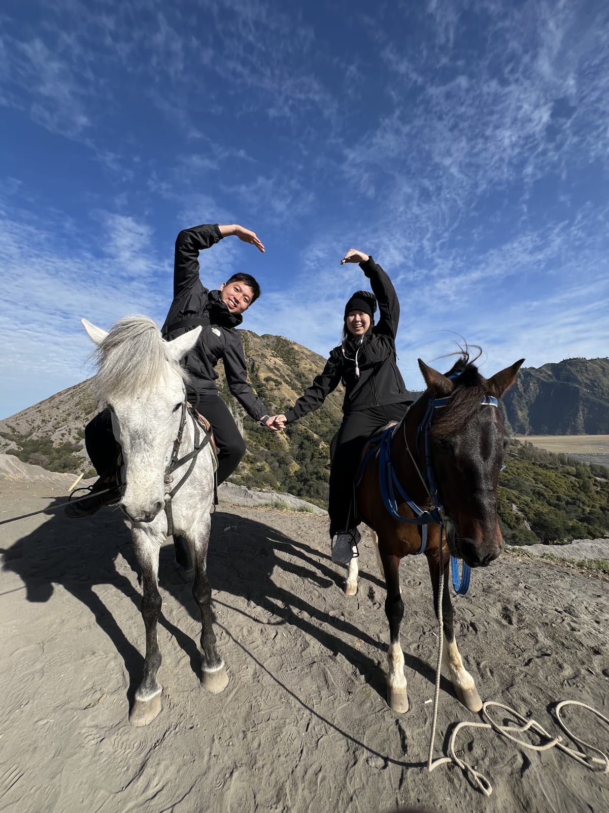 2 humans on horse with heart sign