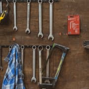 Wrenches and hand tools hanging on a workshop wall