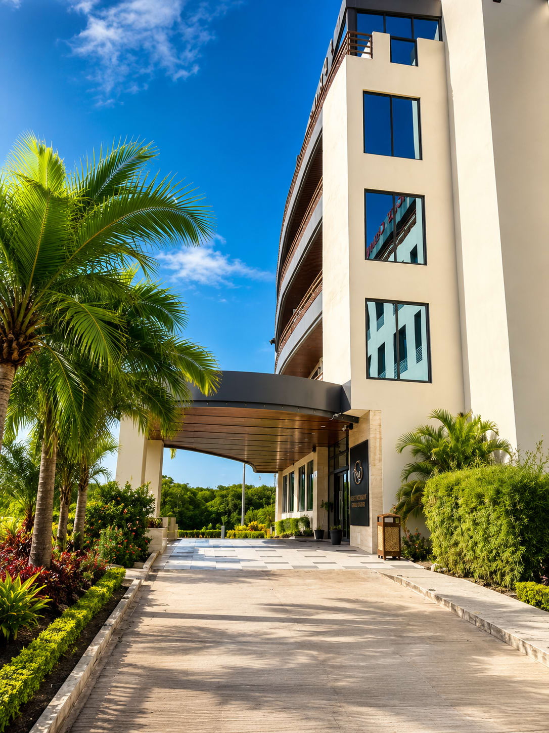 Grand Resort and Residences Belize riverside hotel exterior at golden hour