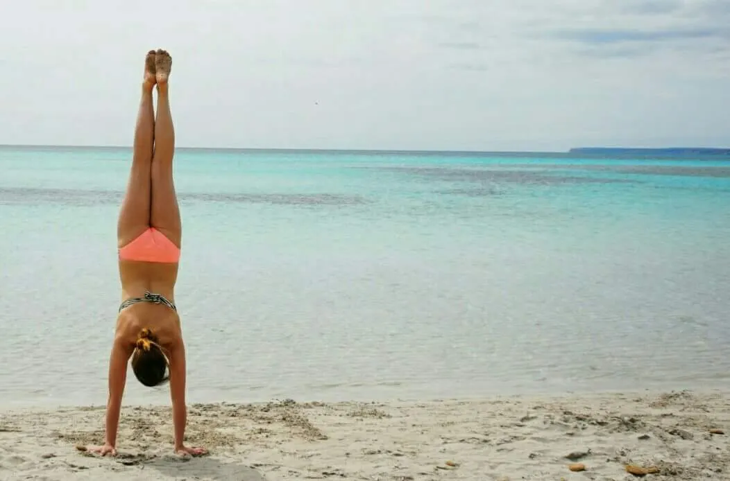Nina handstands at the beach