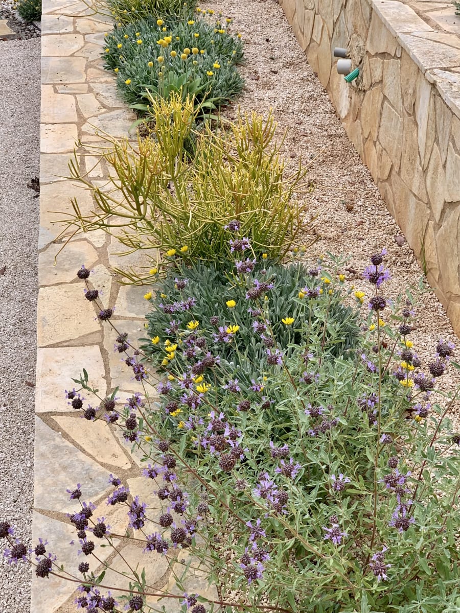 Permeable gravel surface with crushed stone drainage layer in garden path