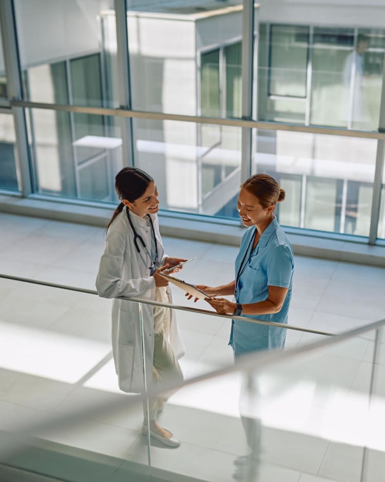 Two female doctors in a hospital. Polygons services within property damage control combine 24/7 emergency response, restoration and monitoring.