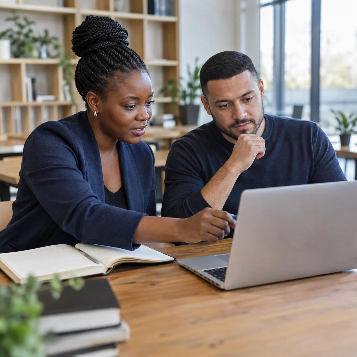Illustrative education scene: an instructor and adult learner reviewing course material