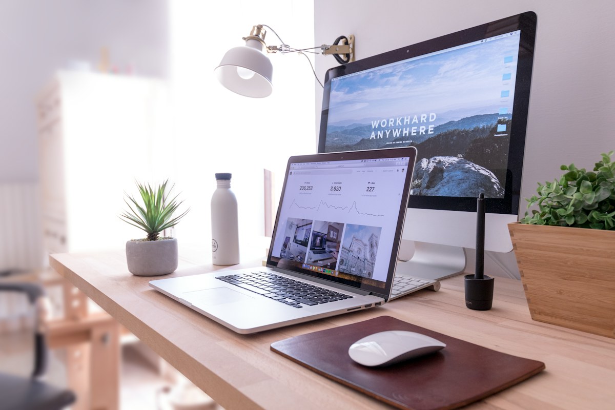 Website design workspace with laptop and desktop computer