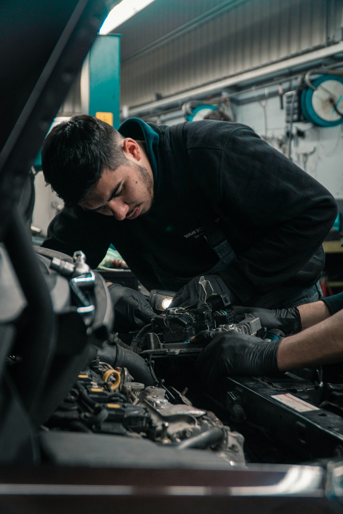 Mechanic maintaining a vehicle engine