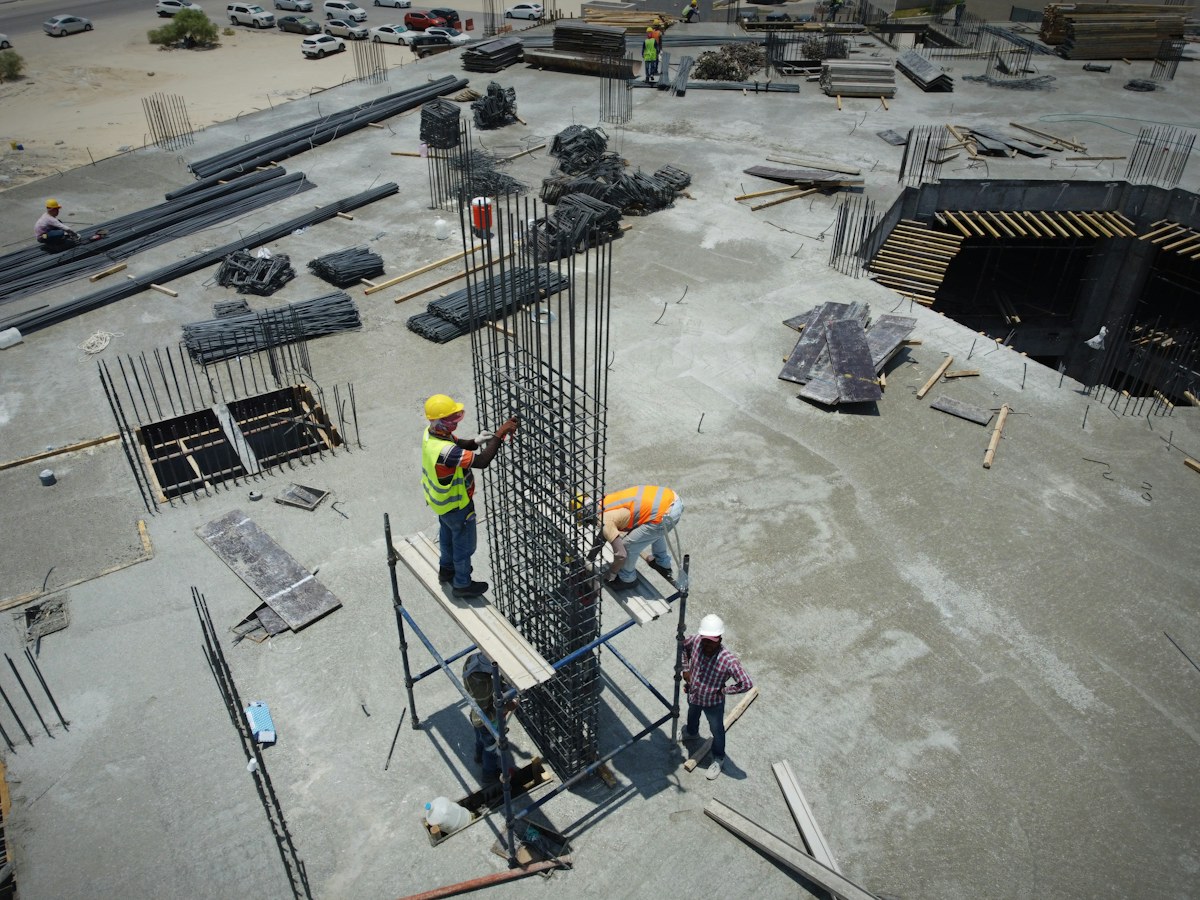 Construction workers standing at an active building site
