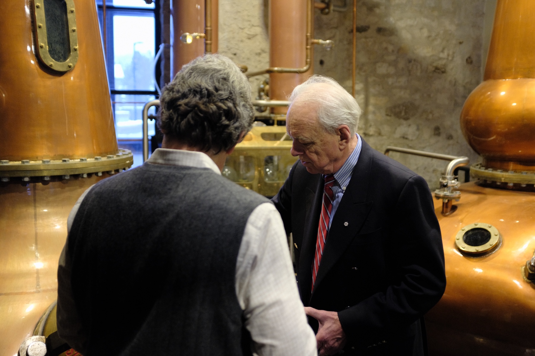 John W. Sleeman showing Jose Manuel Aldomar details of the Forsyth copper pot stills.