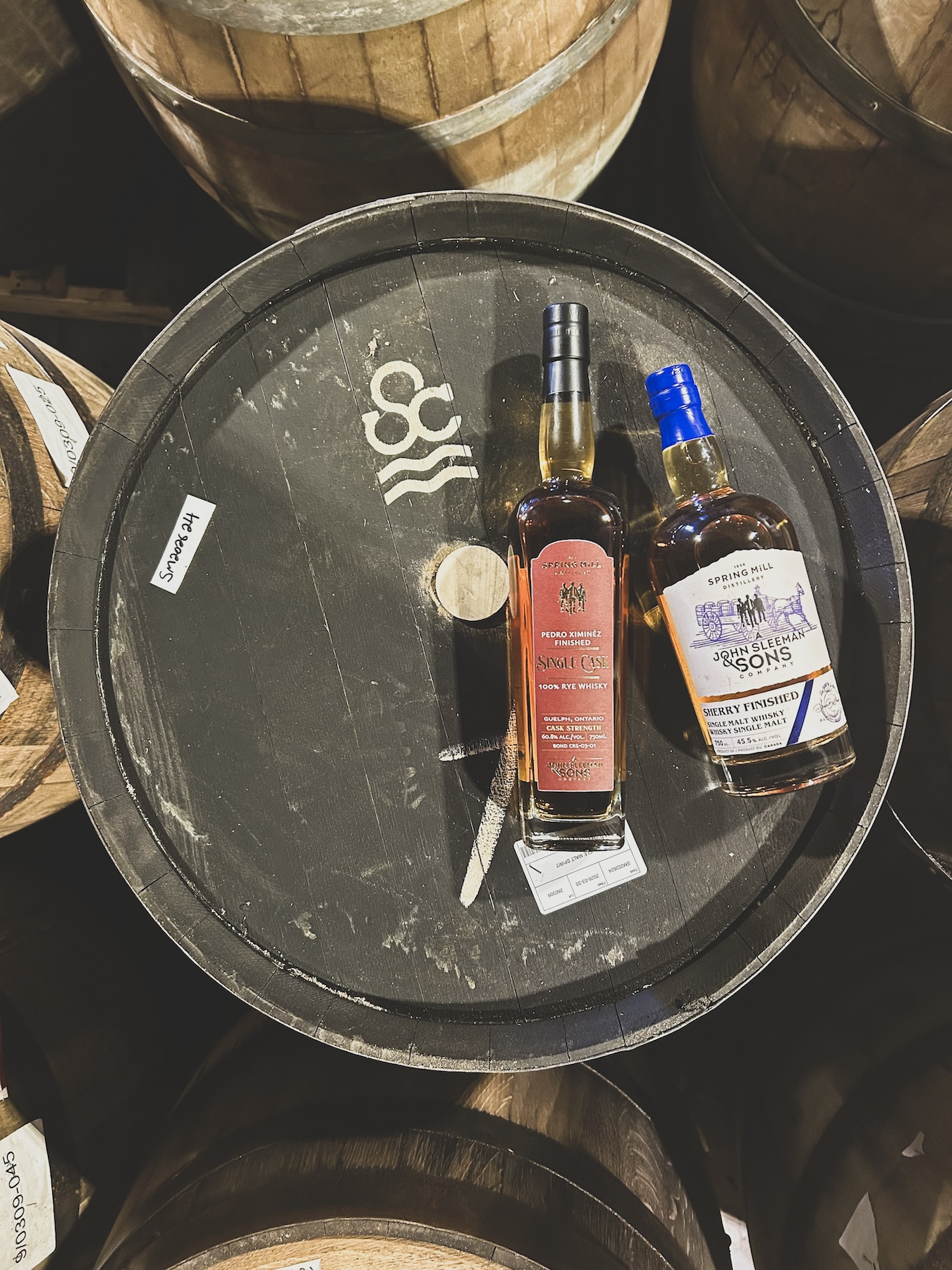 The two sherry finished gold medalists sitting atop a Solera Cask at Spring Mill Distillery.