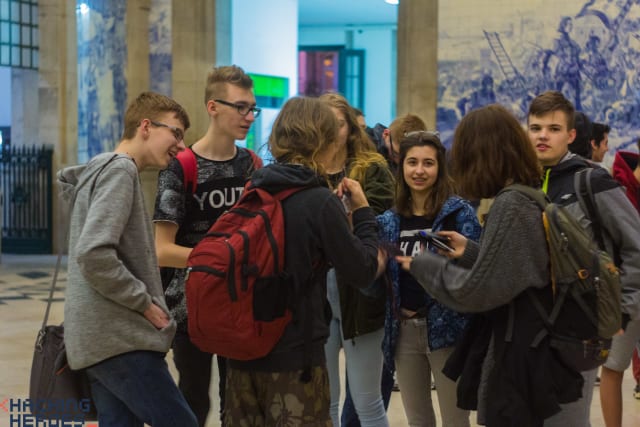 Participants in a corridor, several taking photographs