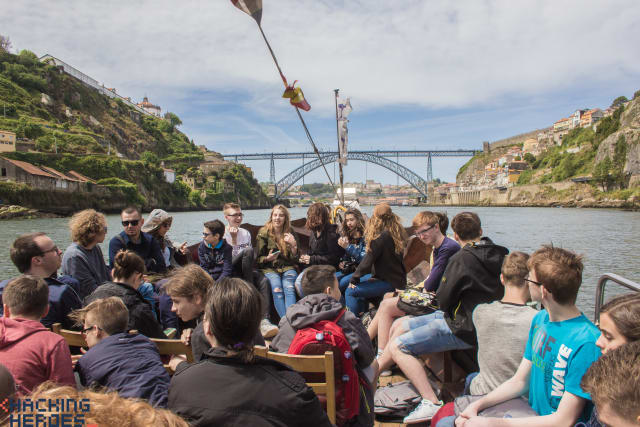 The group gathered by the river, the bridge behind them