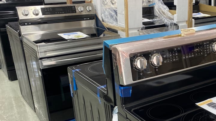 An aisle of new electric and gas ranges