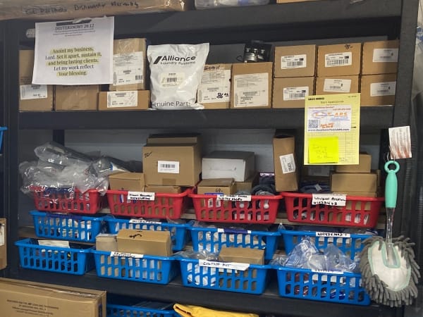 Labeled bins of replacement parts behind the counter