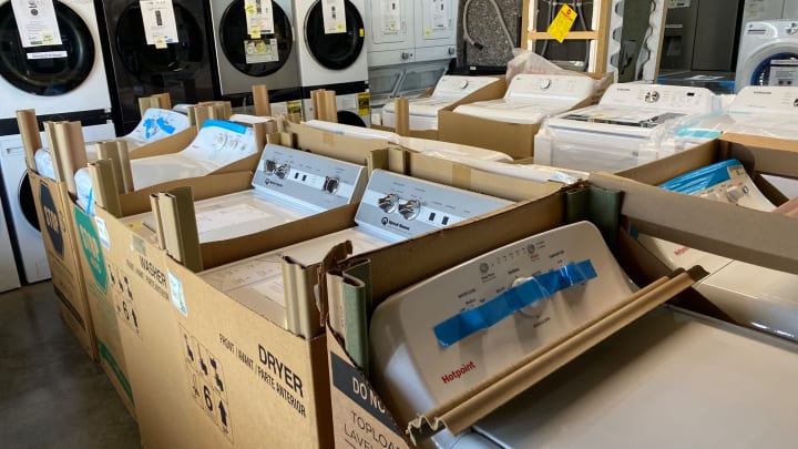 New Speed Queen, GE and Hotpoint washers in their shipping boxes