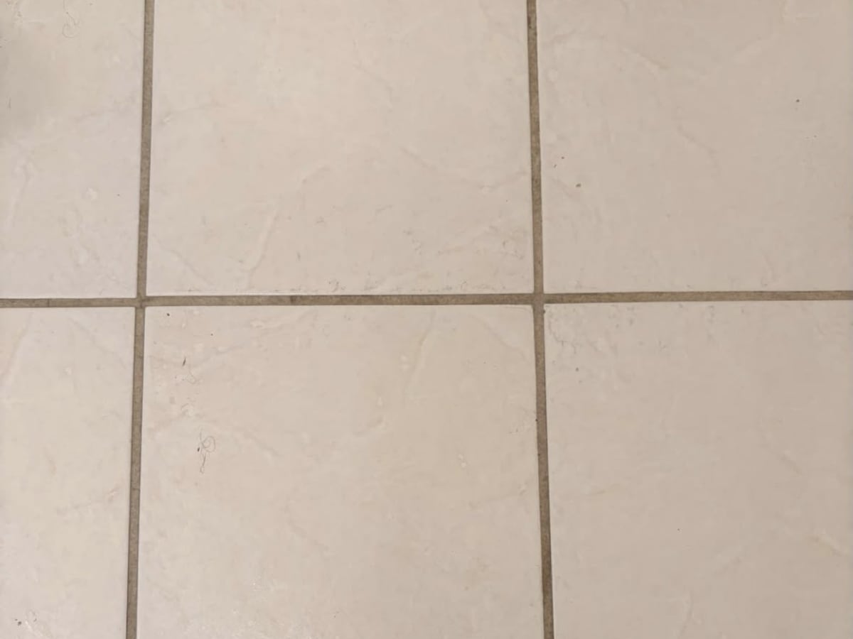 Cream tile floor with the grout scrubbed clean