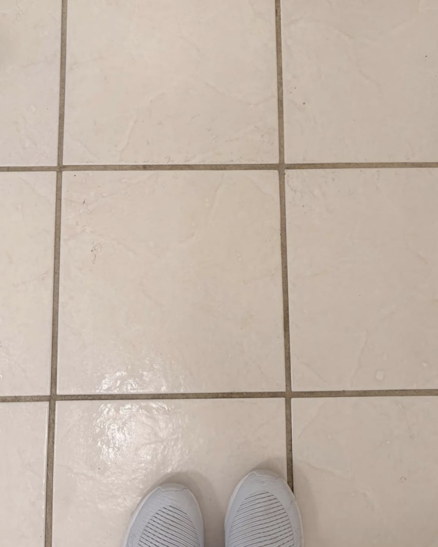 Cream ceramic floor tile with the grout scrubbed clean